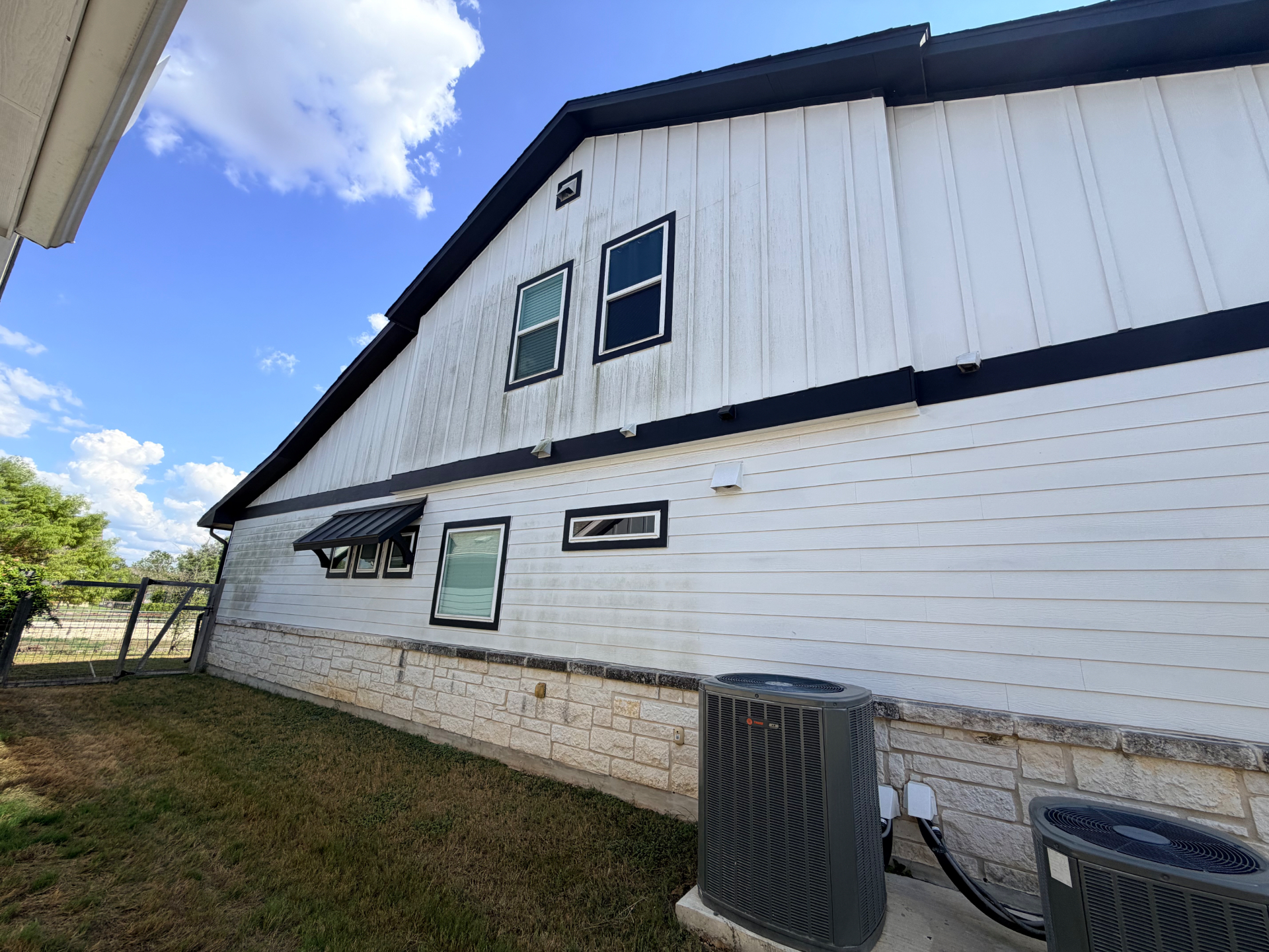 House siding before a professional pressure wash